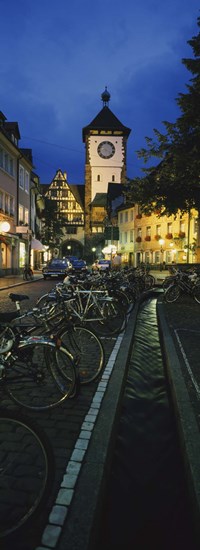Bicycles parked along a stream near a road, Freiburg, Baden-Wurttemberg, Germany by Panoramic Images art print