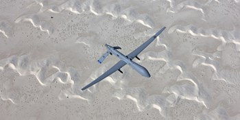 An MQ-1 Predator Flies over the White Sands National Monument, New Mexico by HIGH-G Productions/Stocktrek Images art print