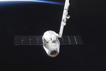 The SpaceX Dragon Cargo Craft Prior to Being Released from the Canadarm2 by Stocktrek Images art print