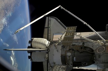 A Soyuz Vehicle and the Space Shuttle Discovery Docked to the International Space Station by Stocktrek Images art print