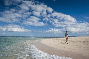 Woman walking on white sand beach of Beachcomber Island, Mamanucas Islands, Fiji by Michael Runkel / DanitaDelimont art print